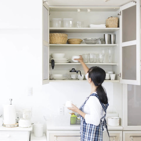 Woman arranging kitchen shelves with 50 Pack Full Overlay Soft Close Cabinet Hinges For Kitchen Cabinets installed.