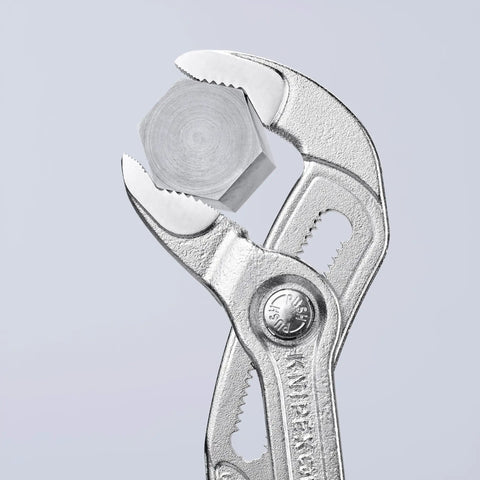 Cobra Pliers With One Hand Quick Adjust Pinch Guard 27 Position gripping a hex nut, showing hardened teeth and secure locking catch.