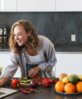 Person in kitchen with fruits and vegetables using laptop near Slim GFCI Outlets 10 Pack 15A 125V ETL Listed Non Tamper Resistant Duplex Receptacles With LED Indicator Self Test Wall Plate Light Almond Finish For Easy Quick NEC Compliant Install.