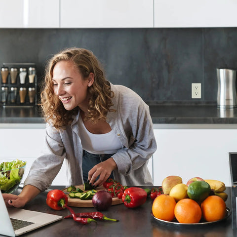 Person in kitchen with fruits and vegetables using laptop near Slim GFCI Outlets 10 Pack 15A 125V ETL Listed Non Tamper Resistant Duplex Receptacles With LED Indicator Self Test Wall Plate Light Almond Finish For Easy Quick NEC Compliant Install.