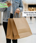 Person holding Big 14 By 10 By 16 Inches Brown Paper Bags With Handles For Takeout And Shopping Large Kraft Bags in a mall