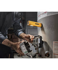 USB-C Rechargeable LED Flashlight With Magnetic Jobsite Light attached to a water heater, illuminating a workspace