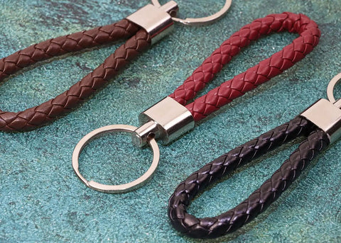 Premium Braided Pu Leather Key Fob With Solid Metal Hardware For Daily Grind Fly Woven Keychain Ring Holds car and home keys in black, brown, and red.