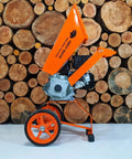 Powerful 6HP Gas Wood Chipper Self Feeding With 208CC 4 Stroke Engine beside stacked wood logs