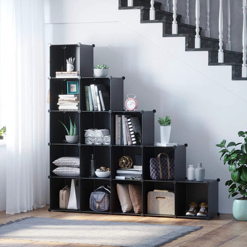 Black 16-cube storage organizer under stairs, space-saving display with books, decor, and household items. 48.4x12.4x48.4 inches.