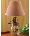Vintage Inspired Butter Churn Lamp Replica With Red Finish Wood Finial And Hand Cranked Turning Mechanism For A Rustic Farmhouse Vibe On Tables Or Shelves.