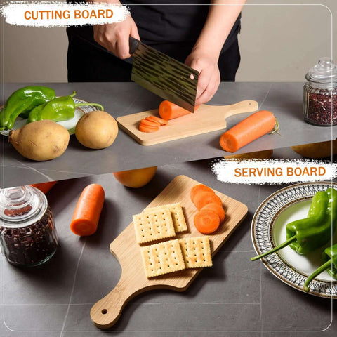 Two bamboo cutting boards on a gray counter; one with a handle slices carrots, crackers arranged on the other.