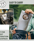 Woman inserting 3L hydration backpack 3L water bladder with food grade TPU into daypack, outdoors setting.