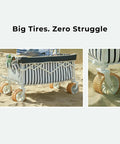 Foldable Beach Wagon With Six Point Seven Inch Fat Tires For Sand And Mixed Terrain No Sweat Easy Pull Cart For Beach And Camping Large Capacity Haul Trunk Ready For Spontaneous Getaways Heritage Navy Stripe features large tires resting on sand.