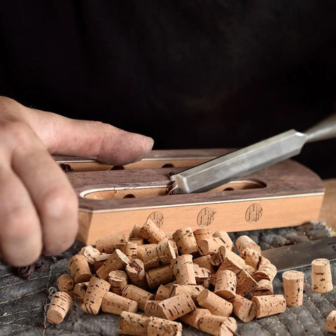 Carpenter Bee Corks 200 Count Kit For Small Holes In Furniture with tapered plugs being placed into wooden surface for repair.