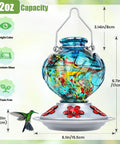 Front view of Hand Blown Glass Hummingbird Feeder For Outdoors Hanging With Bee Proof Ports And Ant Moat 360 Degree Perch Leak Proof 22oz Blue Peony