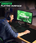 Gamer using Huge 46 By 17 Inch XXL Thick Gaming Mouse Pad For Gamers Extra Large Extended Desk Mat With Smooth Surface And Non Slip Base Black Color For Wide Mouse Movements And Keyboard Setup.