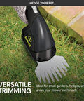 2-In-1 Cordless Grass Shears And Hedge Trimmer For Quick Edging And Shrubs trimming grass along a brick walkway.