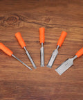 A set of five wood chisels with orange grips displayed on a wooden surface, including the 5 16th Inch Carbon Steel Beveled Edge Wood Chisel With Plastic Non Slip Handle Orange Grip For Woodworking Carving And DIY Projects Built Tough For Real Woodworkers And Carvers Durable Flat Chisel For Precise Cuts.