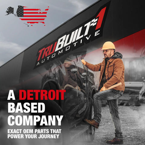 Man standing next to TruBuilt Automotive building with American flag, highlighting Detroit-based OEM parts company.