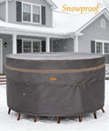 Heavy Duty Round Patio Table And Chair Cover 84 Inch Diameter 28 Inch High Waterproof UV Resistant Dark Grey Fits 84 Inch Tables Or 47 Inch Tables With Chairs Outdoor Weatherproof Protection in a snowy setting