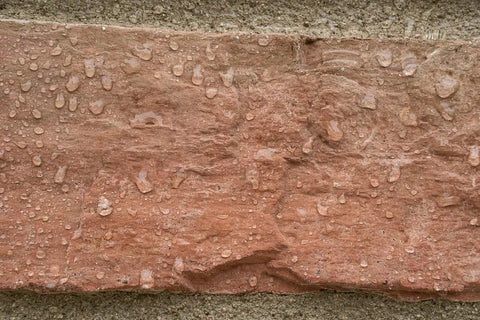 Close-up of water beads on brick surface using All Purpose Outdoor Masonry Sealer For Brick Stone And Concrete Clear Penetrating Waterproof Sealant That Creates A Deep Weatherproof Barrier And Keeps Water Out On Exterior Surfaces 1 Gallon.