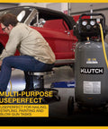 Portable 20 Gallon Air Compressor 2 Hp 120V 175 Psi 4.2 Scfm At 90 Psi With Thermal Overload Protection next to a mechanic working on a car.
