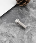 Close-up of a 4Pcs Bike Crank Arm Pinch Clamp Bolt 304 Stainless Steel M6x18mm on a stone surface, part of a replacement kit.