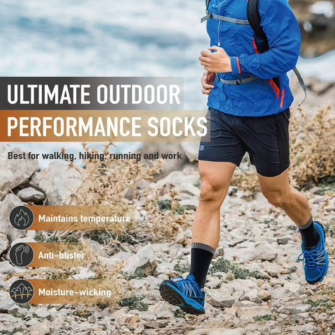 Man running on rocky terrain wearing blue jacket, black shorts, and Merino Wool Hiking Crew Socks For Men And Women, Thick Cushioned Anti Blister.