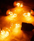 Vintage Clear Glass Edison Bulbs With Warm Filament 11W E26 Base 2200K Warm White Style Replacement Bulbs glowing on paper