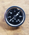 Front view of a round motorcycle oil pressure gauge with black face, white 0–60 PSI markings and chrome bezel.