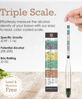 Hand holding a deluxe triple scale hydrometer for home brew with color-coded scale for specific gravity, ABV, and Brix readings.