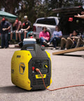 Ultralight 2500-Watt Inverter Generator With Quiet Tech at outdoor event, showcasing portable power features.