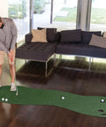 Man using Indoor Putting Green For Home Golf Practice With Realistic True Roll, Three Cups And Workable Bunkers Behind Holes