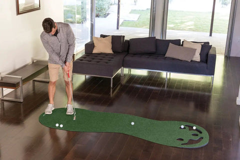 Man using Indoor Putting Green For Home Golf Practice With Realistic True Roll, Three Cups And Workable Bunkers Behind Holes