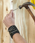 Person using hammer and Magnetic Wristband For Tools With Fifteen Strong Magnets And Breathable Mesh Keeps Nuts, Bolts, And Screws Handy On The Job Ideal Father Gift Durable Wrist Belt For Tools And Small Metal Fasteners holding nails on wrist