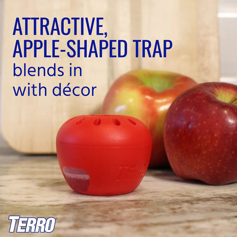 Red apple-shaped Indoor Fruit Fly Trap Kit With Built In Window Ready To Use, 2 Traps And 90 Day Lure Supply on a counter.