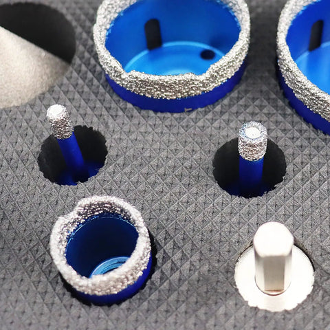 Close-up of diamond core drill bit set for porcelain tile ceramic marble granite with core bits and adapter displayed on textured surface.