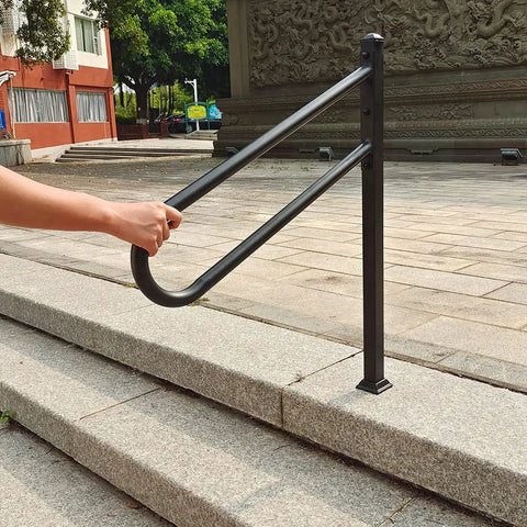 Person holding Sturdy Metal Outdoor Stair Handrail For One To Three Steps Single Post Wrought Iron Design Matte Black Rust Proof Railing