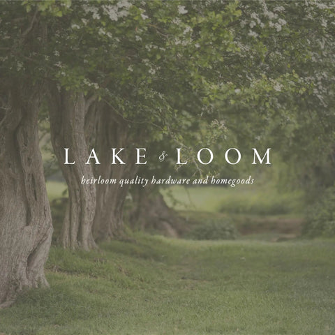 Scenic path through lush greenery with text 'Lake & Loom heirloom quality hardware and homegoods' overlay.