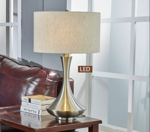 Aladdin Two Light LED Table Lamp With Dimmable 360 View Bulbs, 28.5 Inch Brushed Steel on wood desk in modern living room.