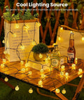 Outdoor Waterproof Solar String Lights 2 Pack, 72 Ft Total, 120 LEDs, 8 Lighting Modes glowing on garden table
