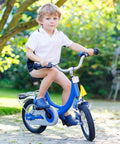 Child riding blue bicycle outdoors
