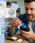 Front view of a man cleaning a camera lens with Pikabeast lens wipes; 200-count pack shown