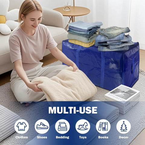 Woman folding blanket next to dark blue 24-gallon storage bag with clothes on top, 8 Pack Heavy Duty Large Moving Bags With Tough Zippers And Built In Carry Handles For Easy Heavy Lifting, Sturdy Clothes Storage Totes And Bins, Packing Bags For Moving Or College Dorms, Dark Blue 24 Gallon.