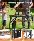 Portable Folding Grill Table With 3 Level Adjustable Height For Outdoors, Lightweight Aluminum Camping Table with mesh bag in use.