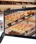 Straight Fire 15.6 Inch Digital Signage Display With 1080P LCD Panel showcasing bakery items with remote control and smartphone.