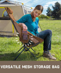 Person sitting on Zeta L8 Max Camping Chair With Carry Bag, showing mesh storage, 25 degree gentle tilt, supports up to 250 lbs, brown.