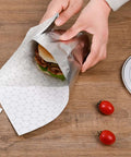 Wrapping a burger with Insulated Foil Wrap Sheets 12x12 Pre Cut Greaseproof And Waterproof For Sandwiches, Burgers, Hot Dogs, Burritos.