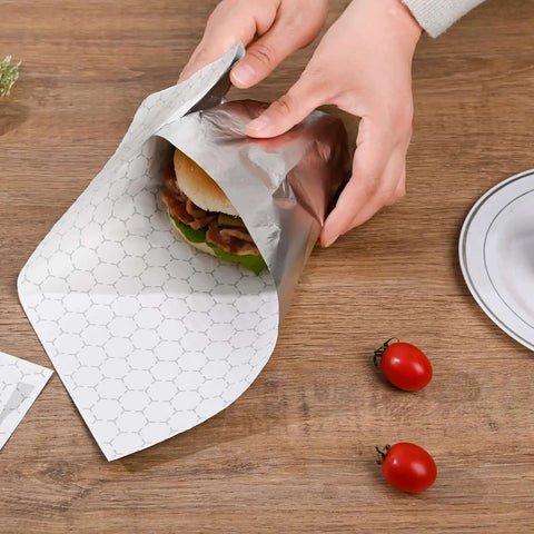 Wrapping a burger with Insulated Foil Wrap Sheets 12x12 Pre Cut Greaseproof And Waterproof For Sandwiches, Burgers, Hot Dogs, Burritos.