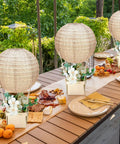 12 Sets Burlap Paper Lanterns and Wooden Centerpieces Kit for Baby Shower and Wedding Decor on outdoor dining table.
