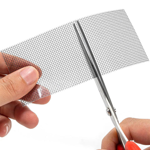 Close-up of Heavy Duty Black Window Screen Repair Tape 2 Inch By 30 Foot Fiberglass Patch being cut with scissors