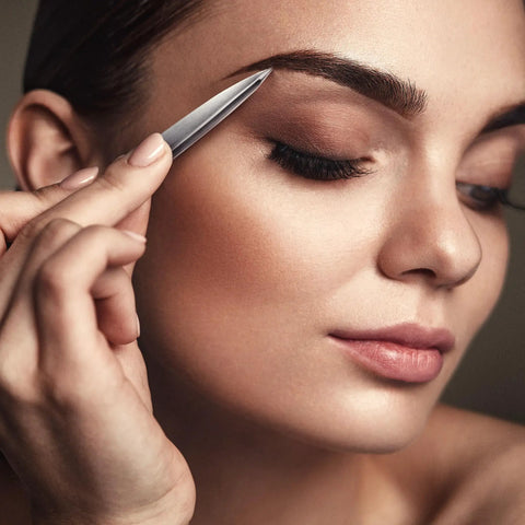 Woman using Pointed Tweezers Pro Grade High Carbon Stainless Steel Needle Nose Fine Point For Precision Hair Removal on eyebrow.