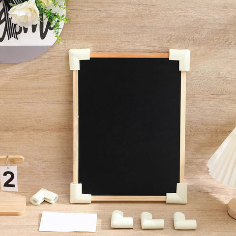 White Foam Corner Protectors 12-Piece U-Shaped Edge Guards on a blackboard frame with extra pieces on table