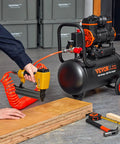 Ultra Quiet 4.8 Gallon Oil-Free Air Compressor With 1.2HP Motor Delivers 2.2 CFM At 90 PSI And 116 PSI Max connected to a nail gun